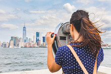 USA, New York, Woman Looking At Manhattan Skyline With Coin-operated Binoculars