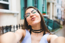 Happy Teenage Girl In The City Taking A Selfie
