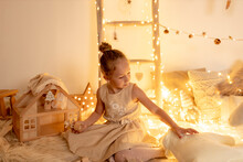 Little Girl Playing With Teddy Bear In Room During Christmas