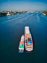 Barge Refueling Recreational Boat On Volga River Against Sky