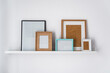 © Manu Prats/Stocksy - Rack of a modern flat with empty picture frames