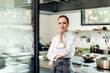 © Sofie Delauw/Stocksy - Confident female chef in contemporary kitchen