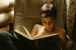 © irina polonina/Stocksy - A young boy reads a book.