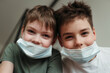 © irina polonina/Stocksy - Young brothers in protective medical masks.