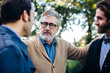 © Sofie Delauw/Stocksy - Senior man supporting adult sons in garden