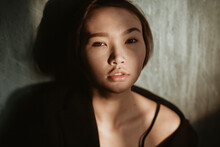 Asian Girl In A Dark Room.