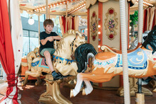 A Child On The City Carousel.