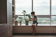 © irina polonina/Stocksy - A young boy takes care of home plants.