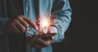 © Looker_Studio - Businessman touching smartphone with light bulbs on the phone screen. ideas of new ideas with innovative technology and creativity.