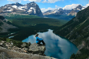 Canvas Print - Middle age woman hiker on cliff above blue lakes in Yoho National Park. Lake O'Hara. British Columbia. Canada 