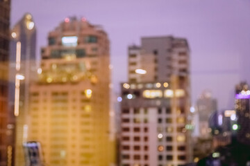 Wall Mural - Blur image of city scape building in the night with light bokeh