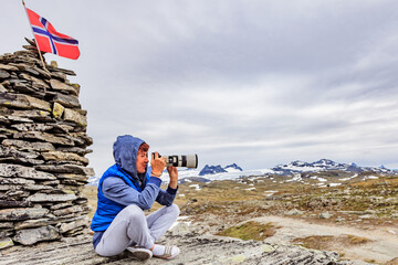 Wall Mural - Tourist with camera in Norway mountains