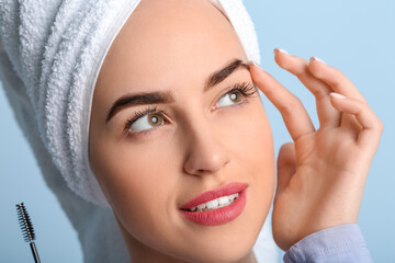 Sticker - Young woman undergoing eyebrow correction procedure on color background