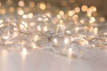 Christmas lights on light background. Decorative garland