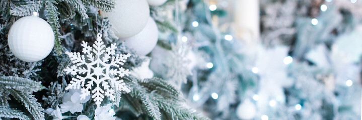 banner. blue christmas decoration, postcard. on the tree a snowflake, balls and a garland.