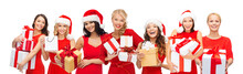 Shopping, Sale And Winter Holidays Concept - Group Of Happy Smiling Women In Santa Helper Hats With Christmas Gifts Over White Background
