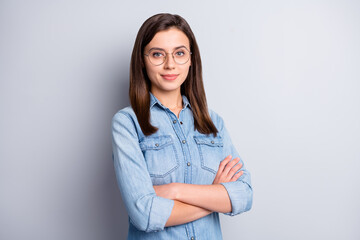 Poster - Portrait of nice intellectual brunette hairdo office worker crossed arms wear spectacles blue cloth isolated on grey background