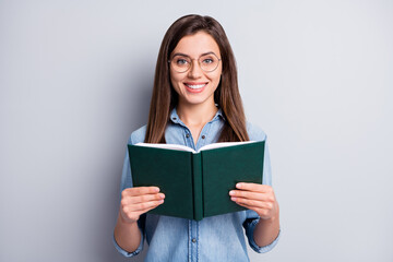 Poster - Photo of optimistic pretty long hairdo lady reading copybook wear spectacles blue cloth isolated on grey color background