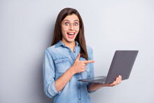 Photo Of Impressed Pretty Long Hairdo Lady Stand Pointing Laptop Wear Spectacles Blue Shirt Isolated On Grey Color Background