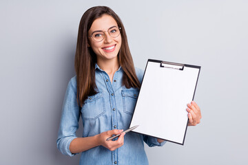 Photo of adorable business person hold pen clip board show sign place isolated on grey color background