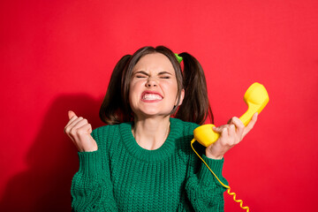 Poster - Photo of mad young woman dressed green knitted sweater hearing awful news retro phone isolated red color background