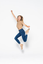 Portrait Of A Cheerful Cute Woman Jumping Isolated On A White Background