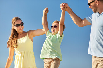 Sticker - family, leisure and people concept - happy mother, father and little son having fun in summer