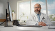 © Gorodenkoff - Experienced Hispanic Male Doctor Wearing White Coat Working on Personal Computer at His Office. Medical Health Care Professional Working with Test Results, Patient Treatment Planning.