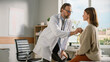© Gorodenkoff - Doctor's Consultation Office: Physician Uses Stethoscope to Listen to Heartbeat and Lungs of the Female Patient. Medical Health Care Specialist Diagnosing, Treating Patient.
