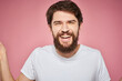 © SHOTPRIME STUDIO - Man in white t-shirt emotions lifestyle facial expression cropped view pink background.
