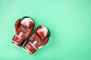 Boxing red gloves on a green background, free space.