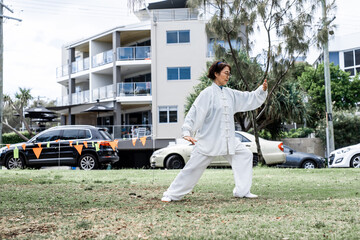 Mature chinese woman do tai chi outdoor in the park