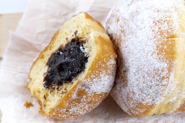 Close-up of donuts , Berlin pancakes, dusted with powdered sugar served on a rustic wooden table