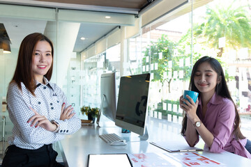 cropped shot of two ui developers meeting on their project with paperwork and tablet on meeting tabl