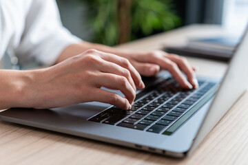 female hands office manager typing on laptop, closeup of hands on black keyboard. woman office manag