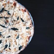Directly Above Of Pizza In Plate On Black Background