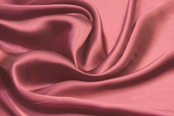Wall Mural - Shining red silk atlas satin fabric with folds, fabric waves. Red pink fabric background. Close up