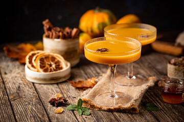 Wall Mural - Pumpkin and orange spiced fall cocktail with cinnamon