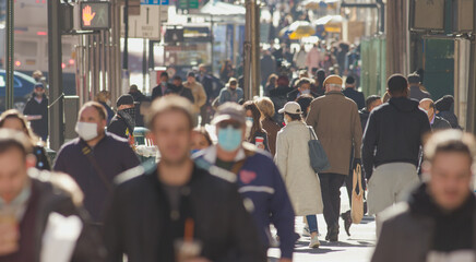crowd of people walking street wearing masks in new york city during covid 19 coronavirus pandemic i