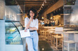 Half length of cheerful Caucaisan entrepreneur feeling success in franchise coffee shop standing in doorway and smiling at camera, happy self employed woman working in local cafeteria industry