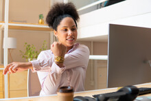 Happy Black Business Woman Stretching Arms In Workstation. Health, Ergonomics, Wellbeing Concept..