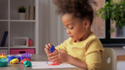 Wall Mural - childhood, creativity and hobby concept - little african american girl with modeling clay playing at home