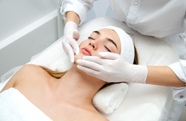 woman getting face beauty treatment in medical spa center.