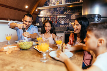 Wall Mural - Latin family having dinner at home