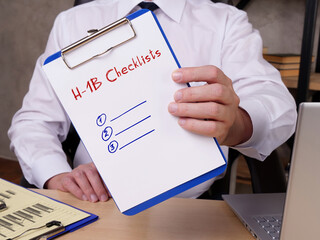  Financial concept about H-1B Checklists with sign on the sheet.