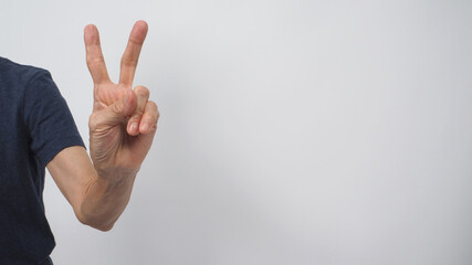 Senior or older woman doing Peace or Good Luck sign.It is for hand gesturing two finger on white background