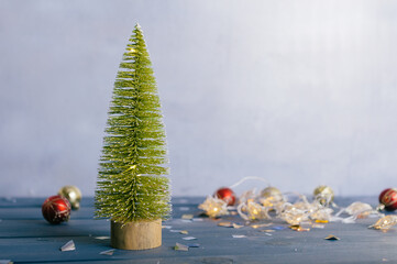 Festive composition for new year and christmas. Christmas tree with decoration on a wooden table.