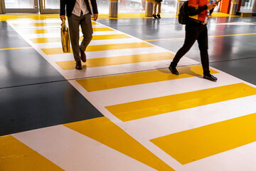 People at the zebra crossing underground Parking. Parking garage underground interior, pedestrian crossing, neon lights in dark industrial building.