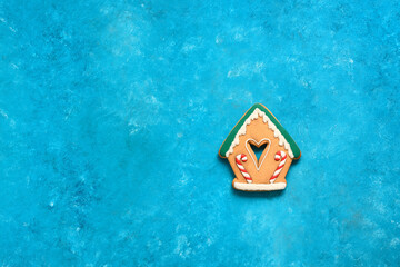 Wall Mural - Gingerbread house on a turquoise blue background. Minimal Christmas composition. Top view, flat lay, copy space