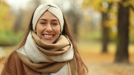 Wall Mural - smiling beautiful young woman enjoy autumn in a public park